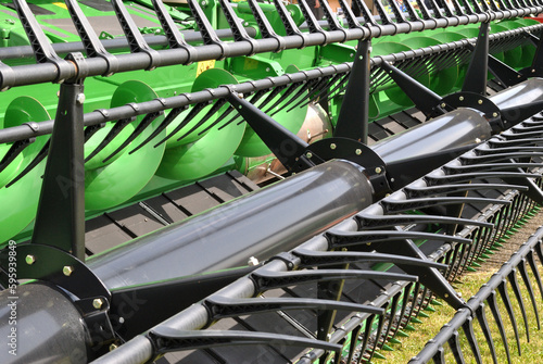 Close Up of Revolving Tines on Modern Agricultural Combine Harvester  photo