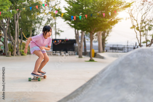 asian child skater or kid girl playing skateboard or ride carving surf skate barefoot to wave ramp or wave bank to fun in outdoor skate park by extreme sports exercise and people surfing surfskate