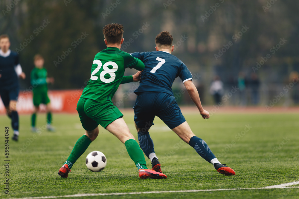 Two College Soccer Teams Playing Soccer League Game. Adult Soccer Players in a Duel. Two Football Players Competing in a Game. European Soccer Tournament Match For Adult Players.