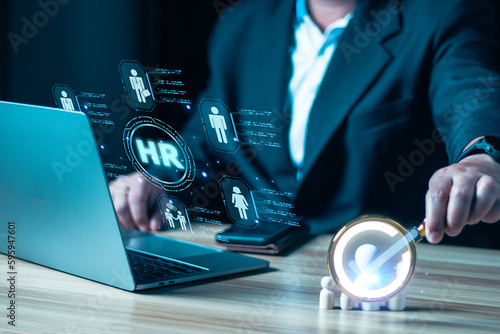 Man looking for employee or leader with magnifying glass and check mark wooden doll, Human Resources, HR management, recruitment, employment, and headhunting concept, marketing segmentation concepts.