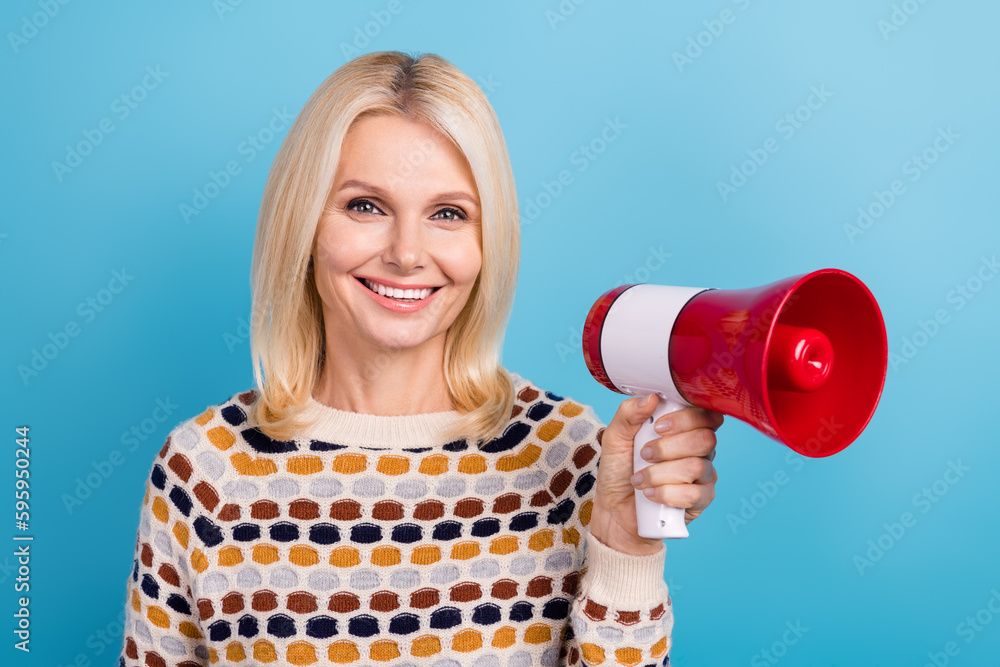 Portrait of nice positive person toothy smile hand hold loudspeaker isolated on blue color background Portrait of nice positive person toothy smile hand hold loudspeaker isolated on blue color background