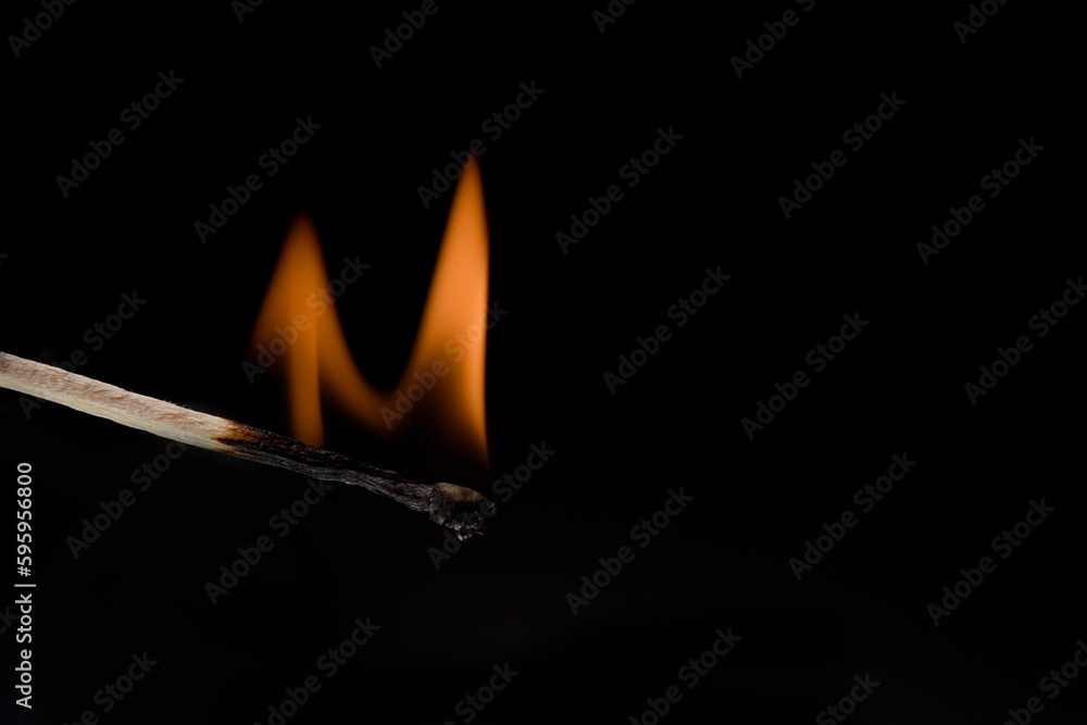 burning match close-up on a black background burning match close-up on a black background