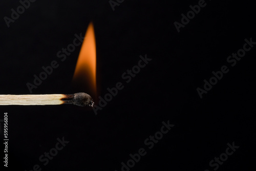 burning match close-up on a black background