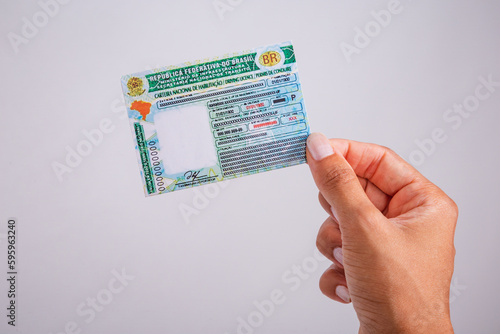 Hand holding driver's license. Brazilian document.