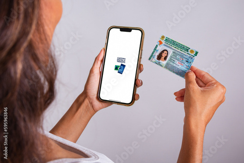 hands holding driver's license and smartphone. Apps.