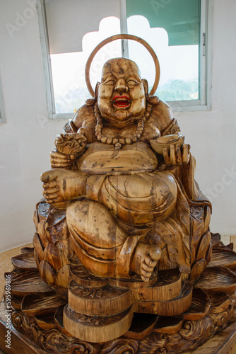Happy chinese Buddha figure in wood at Chinese temple wat Hyua Pla Kang 