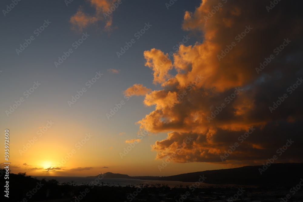 landscape with mountains, clouds, beaches, sky, and orange skies of beautiful Hawaii