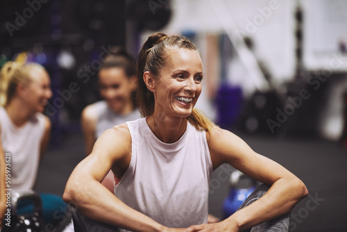 Laughing mature woman relaxing after a class at the gym photo