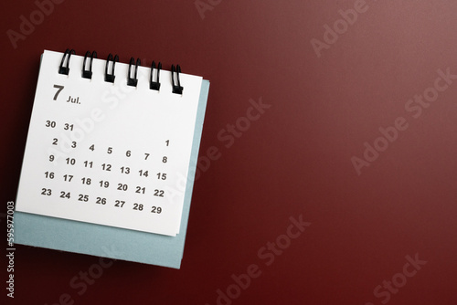 close up of calendar on the red table background, planning for business meeting or travel planning concept