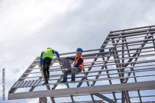 Construction worker outdoor working at roof structure site.