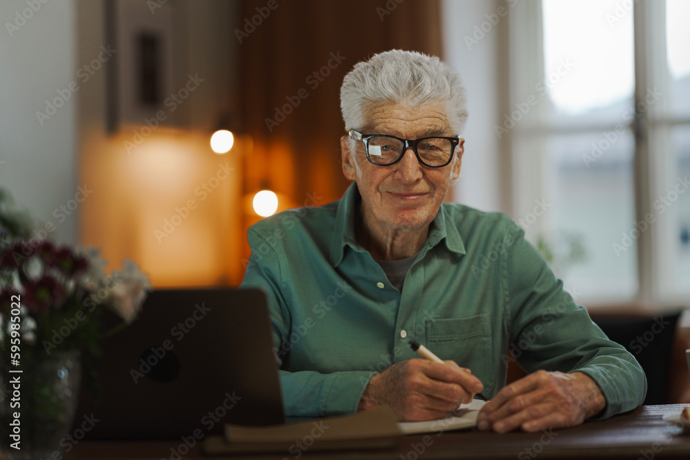 Senior man writing notes in his diary. Senior man writing notes in his diary.