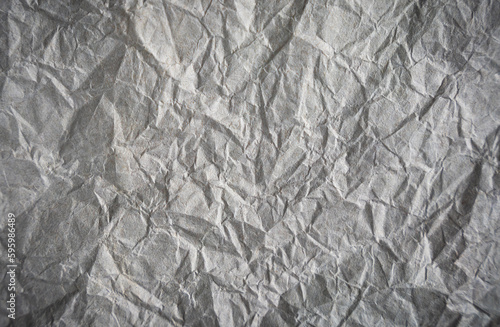 Fototapeta Naklejka Na Ścianę i Meble -  Crumpled gray paper. Abstract background. Banner. Copy space. Selective focus.