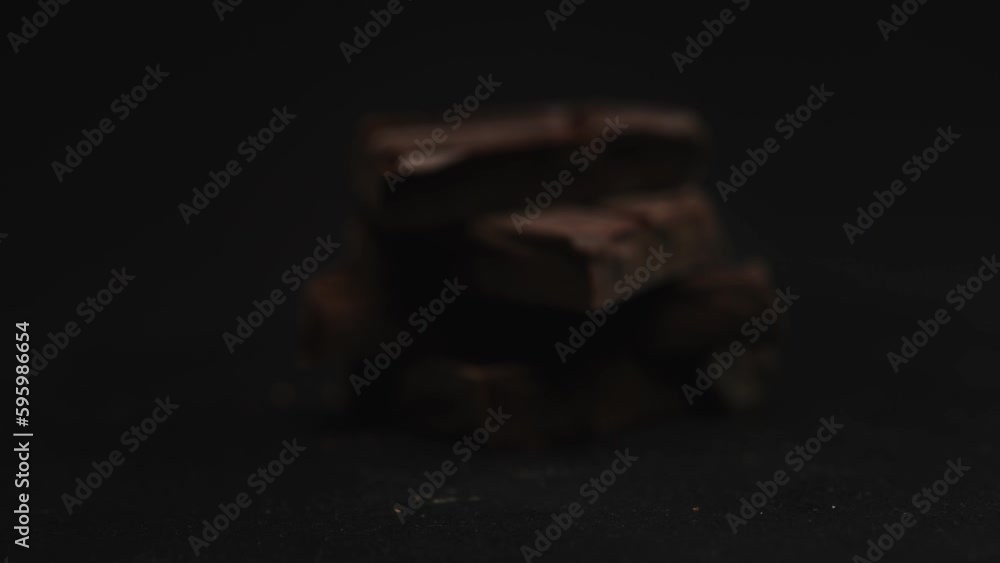 Broken dark chocolate bars. Rotating shot. Broken dark chocolate bars. Rotating shot.