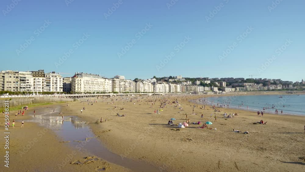 San Sebastian, SPAIN - July 09 2022. Panoramic view of beautiful city San Sebastian - Donostia. View of La Concha Beach. People at the beach. Stabilized static video