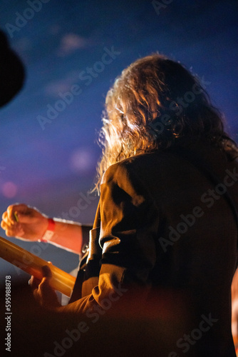 Band playing music and a gig in a venue  close up of a rock band playing guitars and instruments.