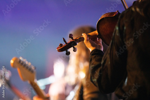 Band playing music and a gig in a venue, close up of a rock band playing guitars and instruments. photo