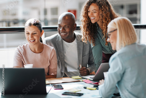 Diverse group of smiling businesspeople working at a table together