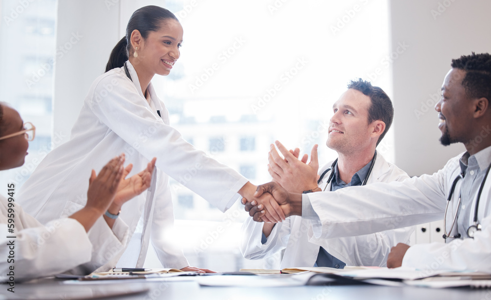 Fototapeta premium Were so happy to meet you. a group of doctors applauding as a new team member is welcomed aboard during a meeting.