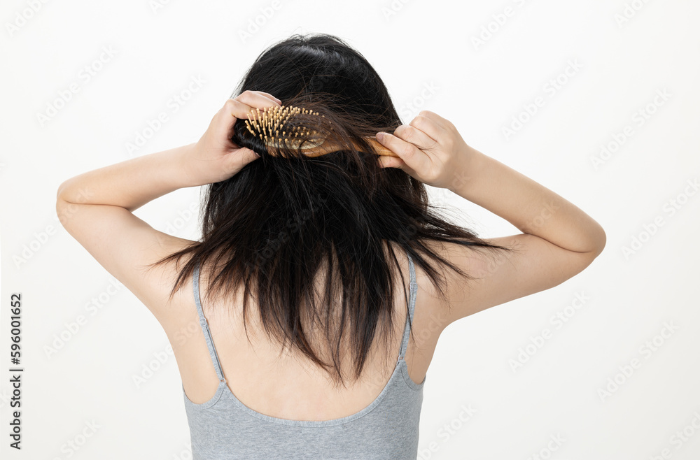 Fototapeta premium Hands combing damaged and tousled hair, back view