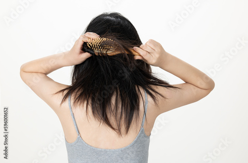 Hands combing damaged and tousled hair, back view photo