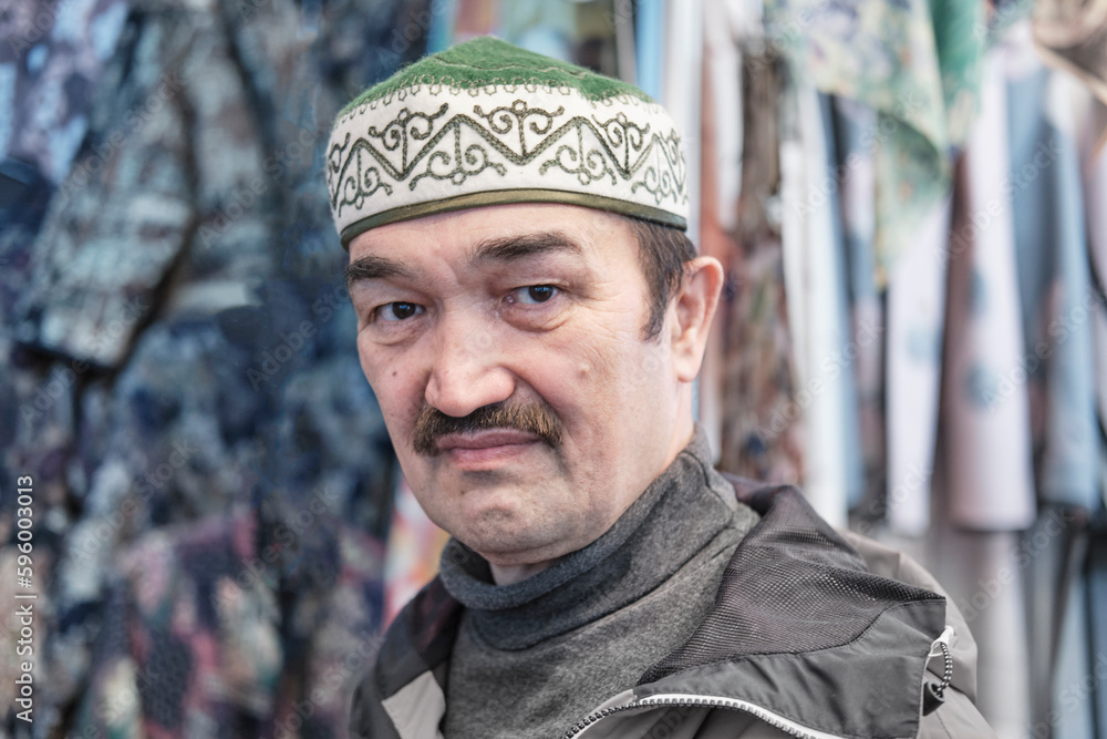 Portrait of senior Asian man wearing Kyrgyz headdress topu. Portrait of senior Asian man wearing Kyrgyz headdress topu.