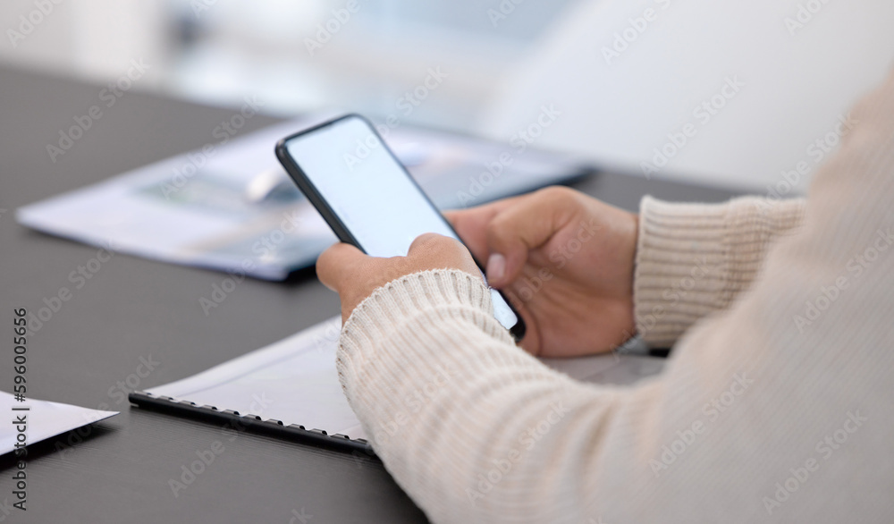 Fototapeta premium It helps to stay connected. Closeup shot of an unrecognisable businessman using a cellphone with a blank screen in an office.