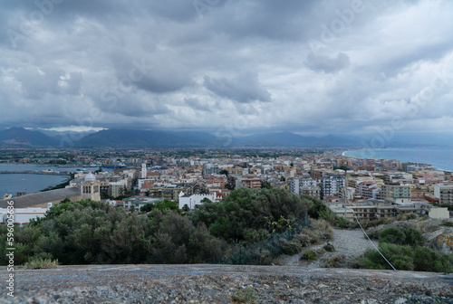 Beautiful milazzo city panoramic dusk view from milazzo castle viewpoint with cloudy sky and messina mountains at background