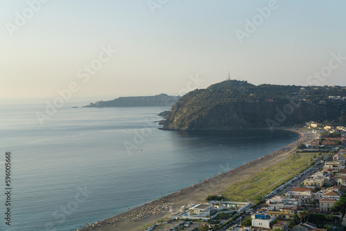 Milazzo shore at dusk with mediterranean sea and coast houses