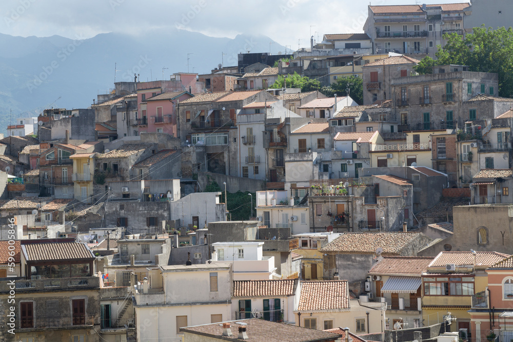 Milazzo tipically neighborhood houses scene in sunny day with messina mountains at background