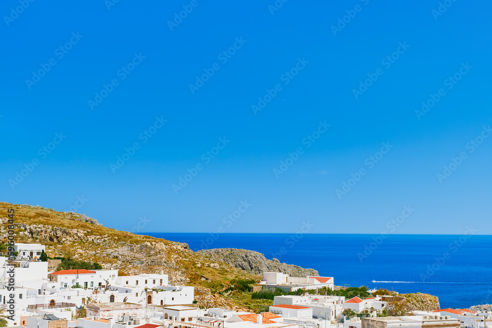 View of the city of Lindos and the emerald sea on the island of Rhodes, the Greek islands of the Dodecanese archipelago, Europe. Holidays and popular travel in Greece