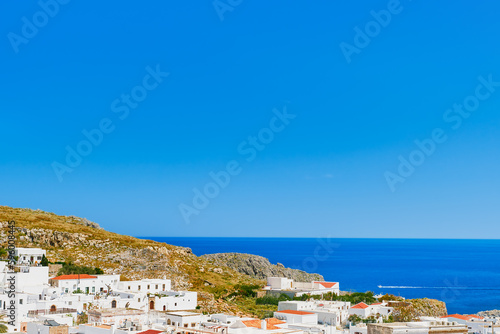 View of the city of Lindos and the emerald sea on the island of Rhodes, the Greek islands of the Dodecanese archipelago, Europe. Holidays and popular travel in Greece