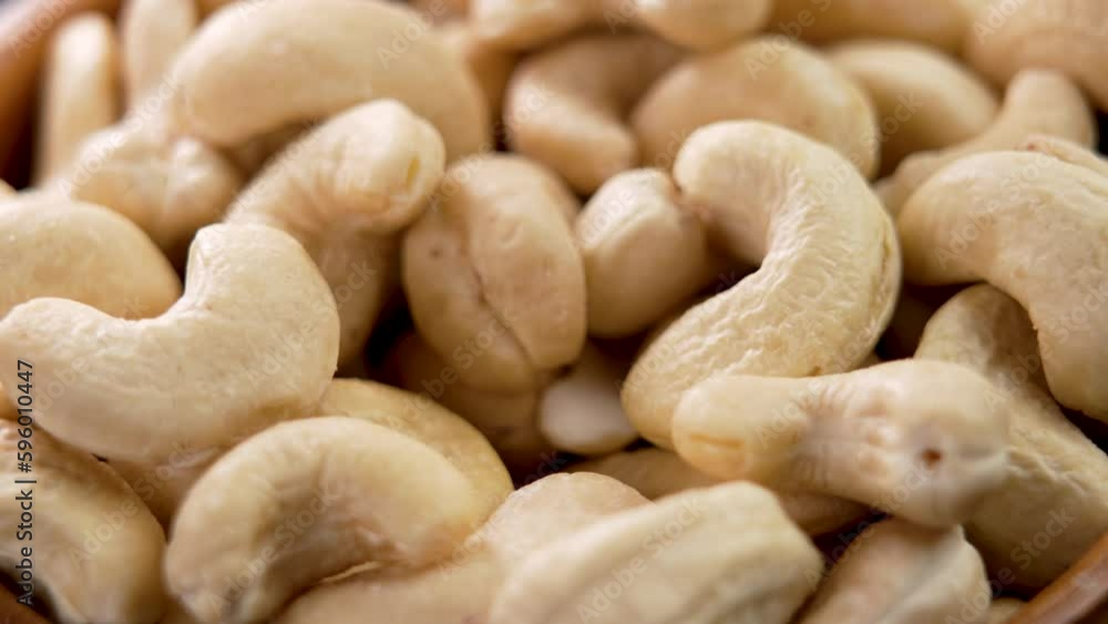 Hand taking dried ready to eat cashew nuts closeup Hand taking dried ready to eat cashew nuts closeup