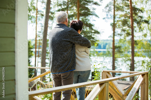 Fotografie Mature couple standing on porch and hugging