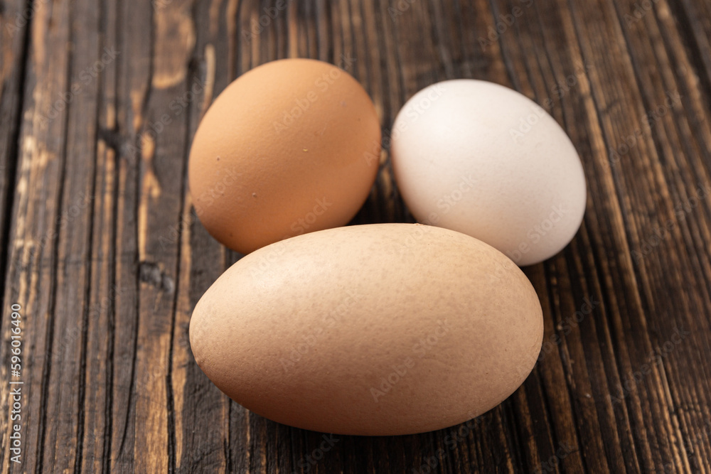 eggs on wooden table, A double-yolked chicken egg on a table eggs on wooden table, A double-yolked chicken egg on a table