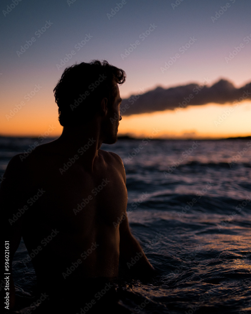 Man wading in the water at Sunset beach in Hawaii Man wading in the water at Sunset beach in Hawaii