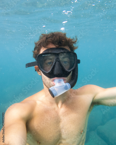 Snorkeler swimming underwater in Hawaii