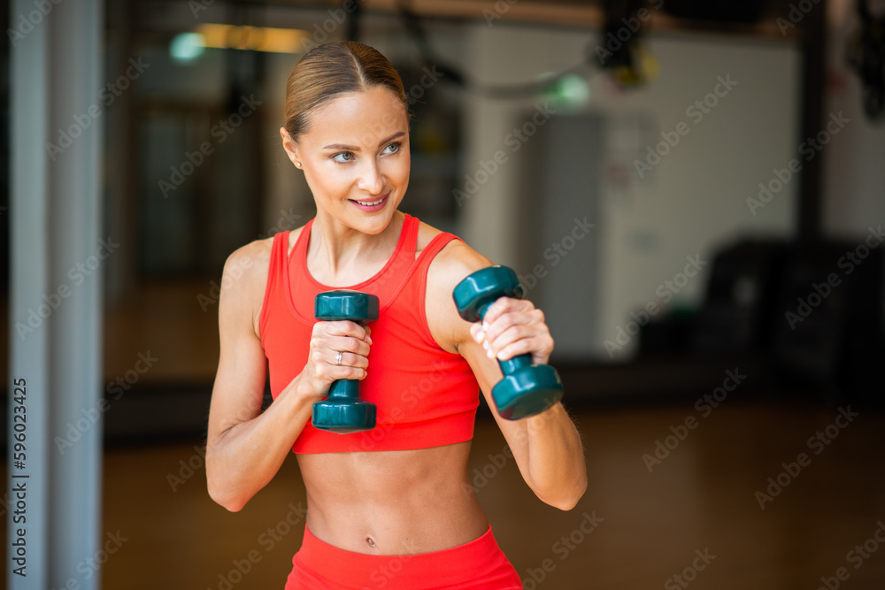 Woman boxing with dumbbells in a gym Woman boxing with dumbbells in a gym