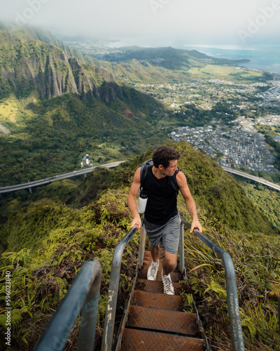 Man Hiking Stairway to Heaven (Haiku Stairs) on Oahu, Hawaii. High quality photo. Looking up the stairs.