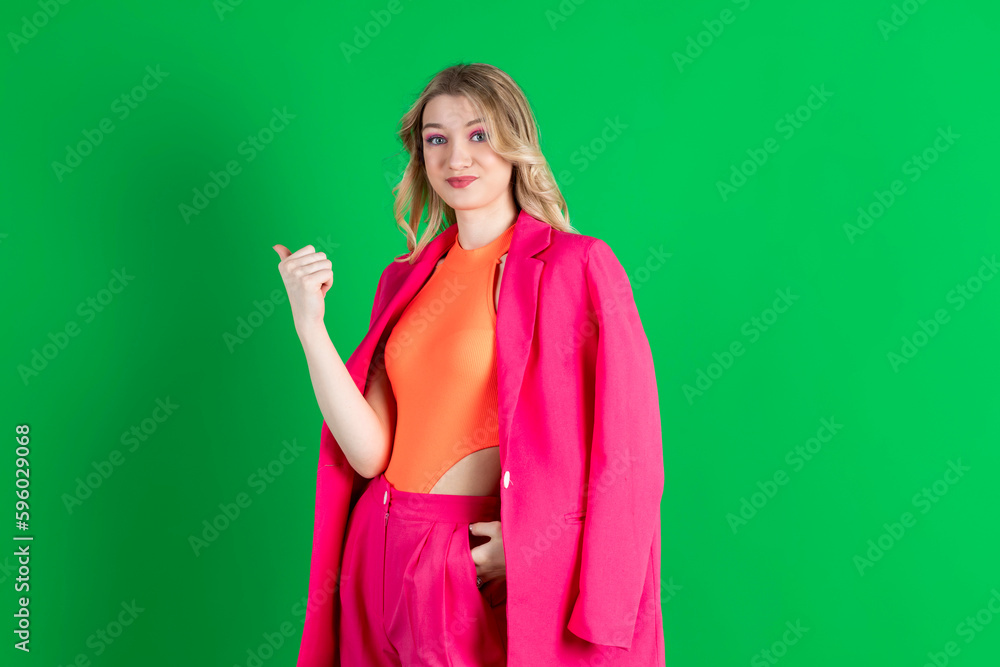 Young curly blonde dressed in pink blazer and pants, asking to move away, gesturing to go. Young curly blonde dressed in pink blazer and pants, asking to move away, gesturing to go.