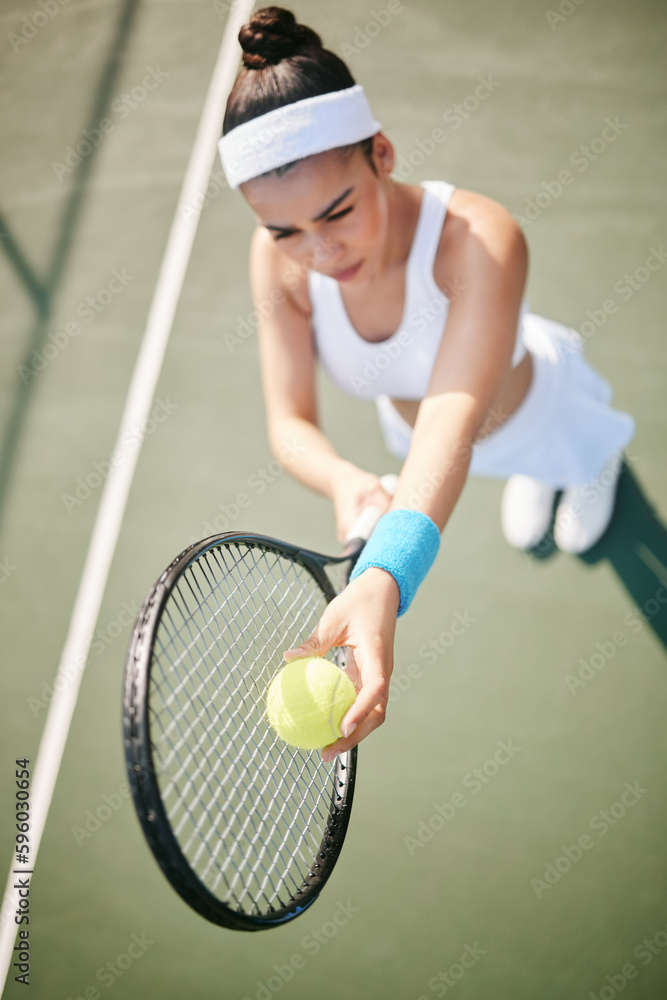 My opponents not going to know what hit them. High angle shot of a young tennis player standing on the court and getting ready to serve during practice.