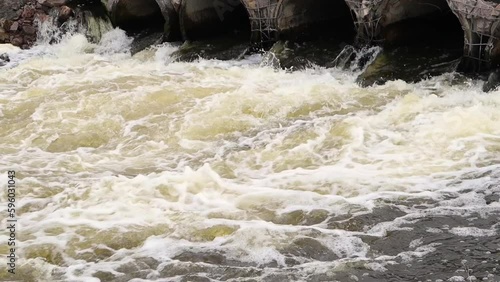 A concrete pipe that carries smelly, polluted sewage into the river through pipes. Pollution of the environment and water bodies. Ecological catastrophy. Hazardous waste water.