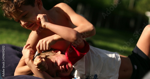 Принти на полотні Brothers quarrel outside in backyard