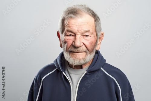 Environmental portrait photography of a satisfied man in his 70s wearing a comfortable tracksuit against a white background. Generative AI