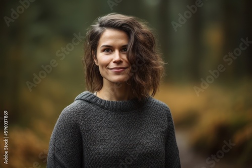 Portrait of a beautiful young woman in the autumn forest. Outdoor.
