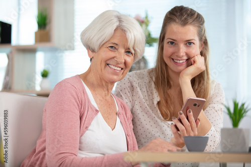 joyful woman and her daughter making selfies