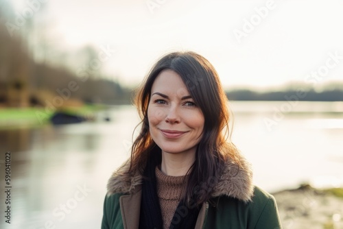 Portrait of a beautiful young brunette woman in a park.