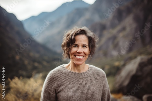 Portrait of a smiling woman on the background of mountains in the Sierra Nevada