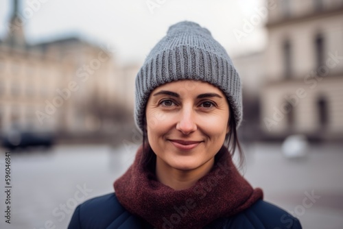 Portrait of a beautiful young woman in a knitted hat and blue coat © Robert MEYNER