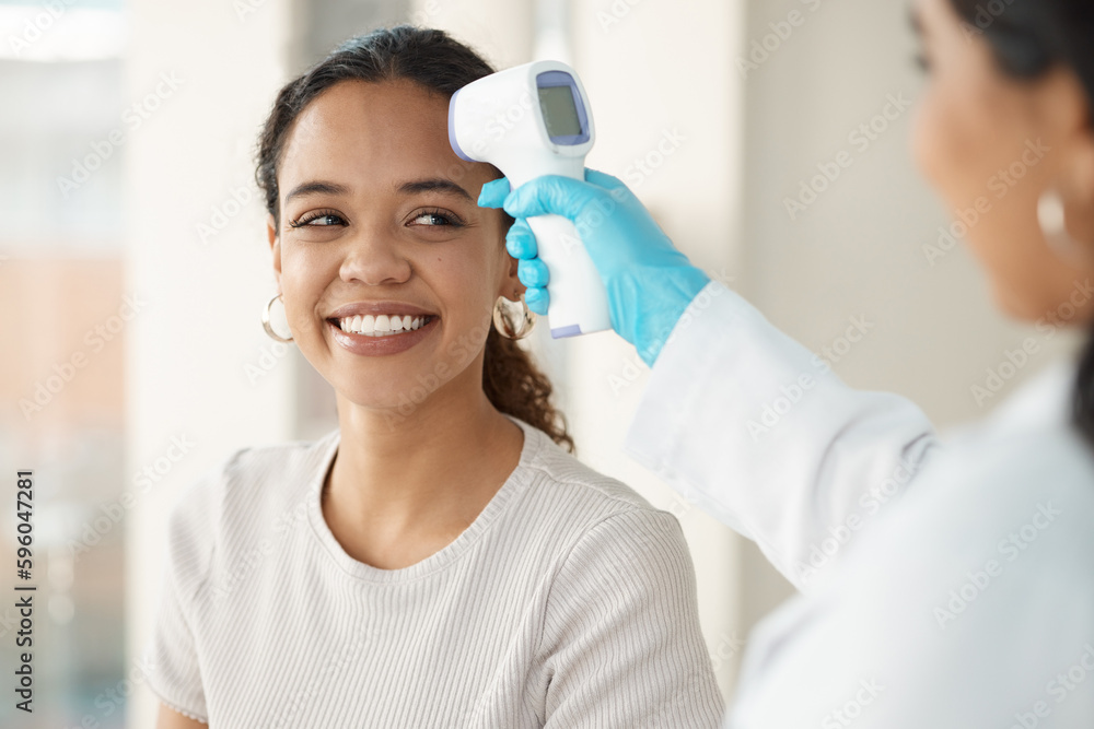 You have a very normal temperature. a young woman sitting in the clinic and getting her temperature checked by her doctor during a consultation. You have a very normal temperature. a young woman sitting in the clinic and getting her temperature checked by her doctor during a consultation.