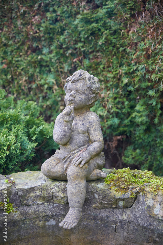 Romantic garden fountain with a boy figure.